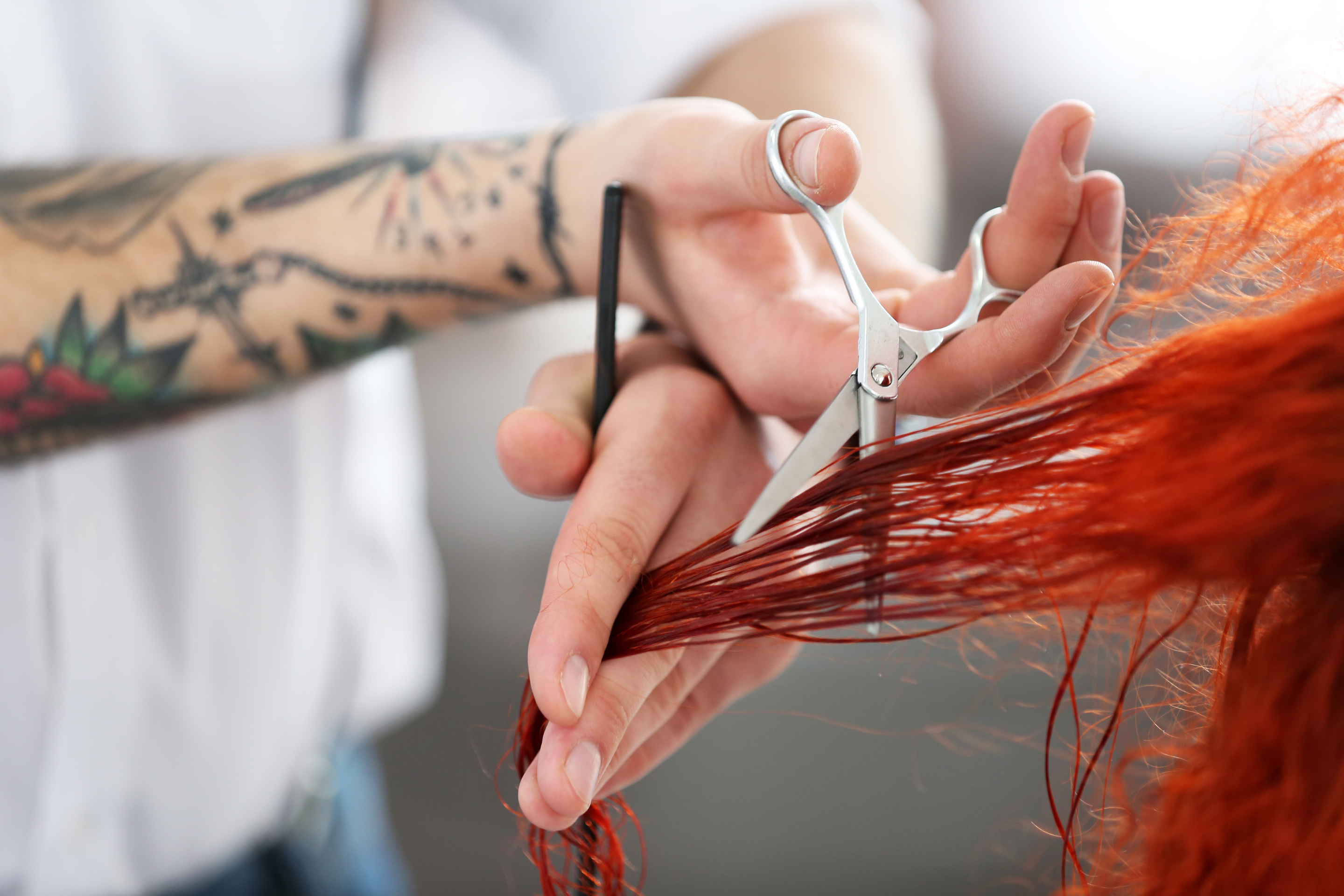 Hairdresser Cutting Red Curls